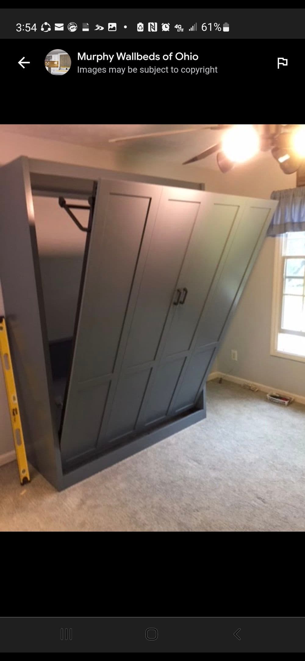 Murphy bed in a modern room, showcasing space-saving furniture design and functionality.