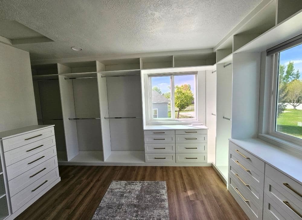 Spacious modern closet with organized storage, shelves, and large window for natural light.